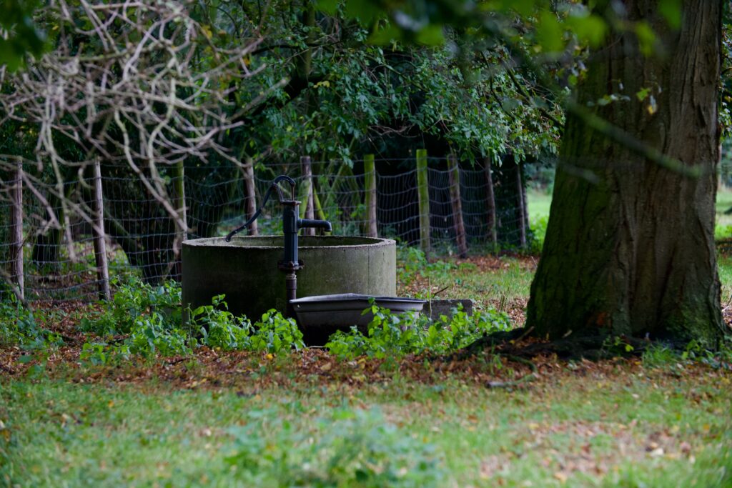 outdoor scene featuring an old water pump and conc 2024 07 18 02 38 00 utc